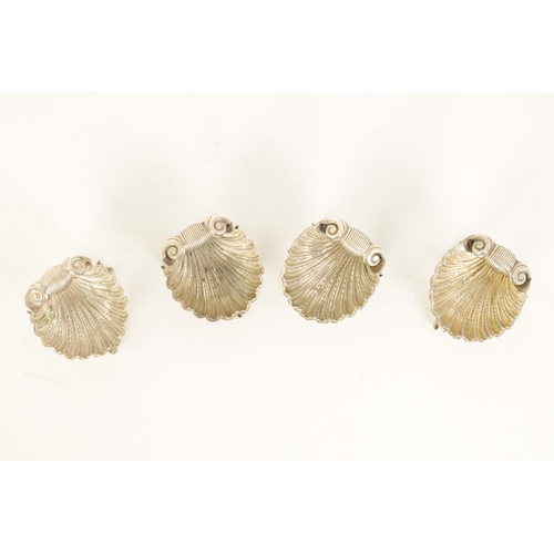 302 - A CASED SET OF FOUR VICTORIAN SILVER ROCOCO STYLE TABLE SALTS formed as shells with dolphin feet and... 