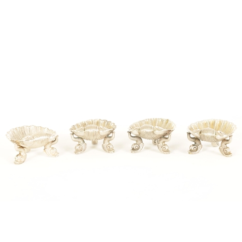 302 - A CASED SET OF FOUR VICTORIAN SILVER ROCOCO STYLE TABLE SALTS formed as shells with dolphin feet and... 