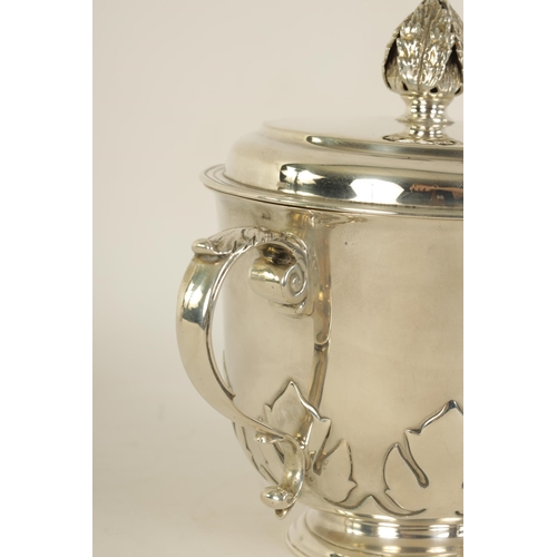 306 - A GEORGE V SILVER PORRINGER the lift-off lid with leaf cast finial above a shaped body with fleur-de... 