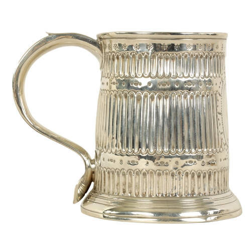 307 - AN EARLY GEORGIAN SILVER MUG the tapered body with fluted and punched decoration, shaped side handle... 