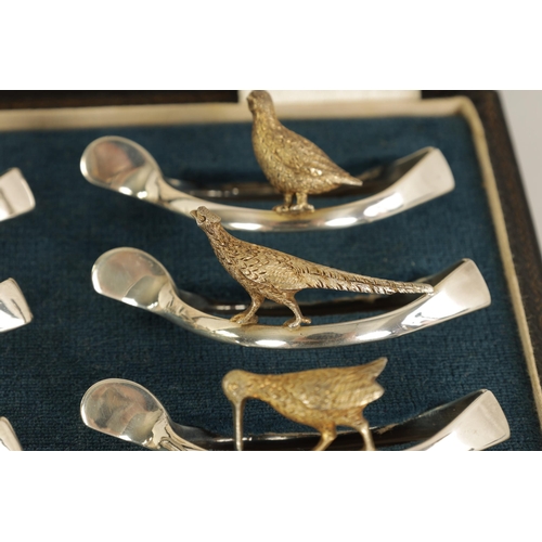 310 - A 20TH CENTURY CASED SET OF 12 SILVER AND SILVER GILT WISH BONE GAME BIRD NAPKIN HOLDERS comprising ... 