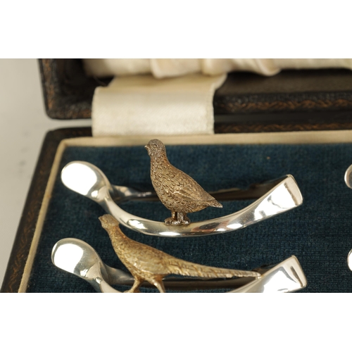 310 - A 20TH CENTURY CASED SET OF 12 SILVER AND SILVER GILT WISH BONE GAME BIRD NAPKIN HOLDERS comprising ... 