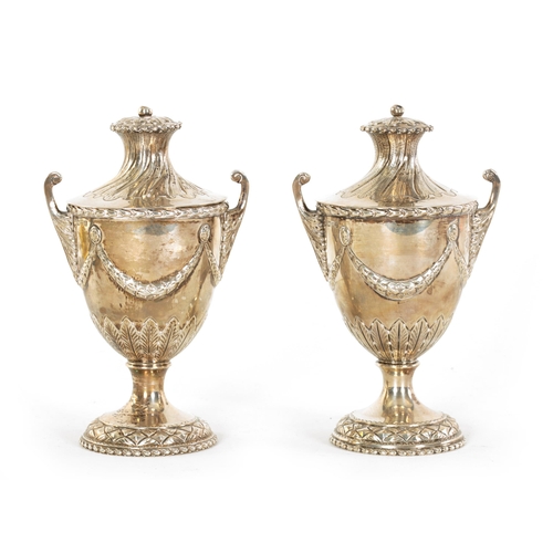 313 - A PAIR OF EDWARD VII ‘ADAM STYLE’ SILVER TEA CADDIES the urn shaped bodies with leafwork handles and... 