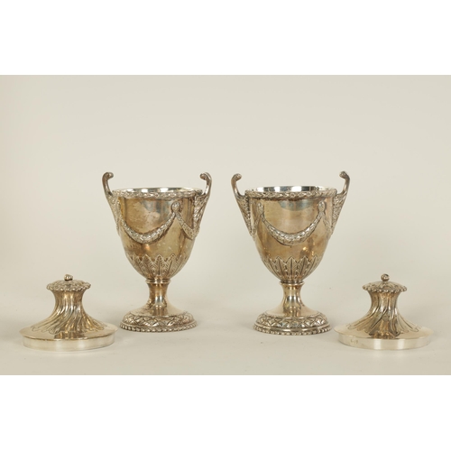 313 - A PAIR OF EDWARD VII ‘ADAM STYLE’ SILVER TEA CADDIES the urn shaped bodies with leafwork handles and... 