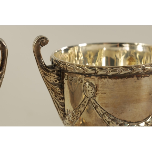 313 - A PAIR OF EDWARD VII ‘ADAM STYLE’ SILVER TEA CADDIES the urn shaped bodies with leafwork handles and... 