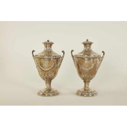 313 - A PAIR OF EDWARD VII ‘ADAM STYLE’ SILVER TEA CADDIES the urn shaped bodies with leafwork handles and... 