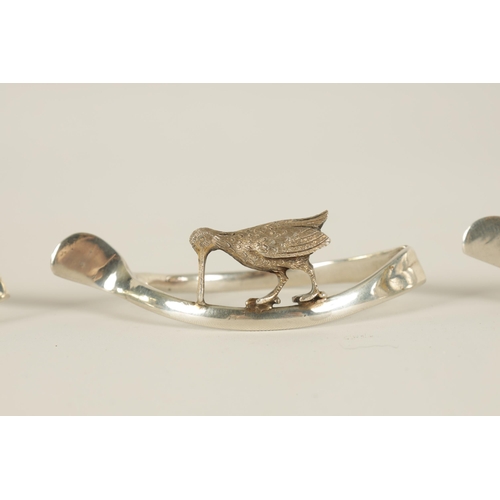 318 - OF COUNTRY SPORTS INTEREST - A SET OF FOUR EARLY 20TH CENTURY SILVER NAPKIN HOLDERS depiciting grame... 