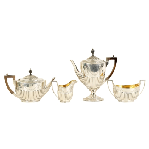 322 - A VICTORIAN SILVER FOUR PIECE TEA SERVICE each piece of oval half fluted form with swag engraved dec... 