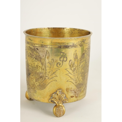 325 - A LATE 17TH CENTURY GERMAN SILVER GILT CYLINDRICAL BEAKER BEARING ENGRAVED FAMILY CRESTS AND INITIAL... 