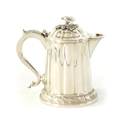 326 - A MID 19TH CENTURY INDIAN COLONIAL SILVER ALE JUG the tapering panelled body on a stepped florally b... 