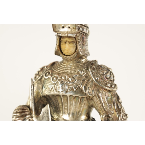 327 - A PAIR OF EARLY 20TH CENTURY GERMAN CAST SILVER SCULPTURES modelled as knights standing on floral pi... 