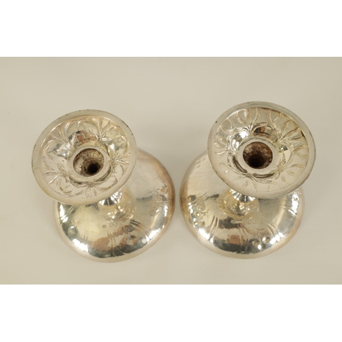 330 - GILBERT MARKS. A NEAR PAIR OF ART AND CRAFTS SILVER TAZZE of circular form with embossed and planish... 