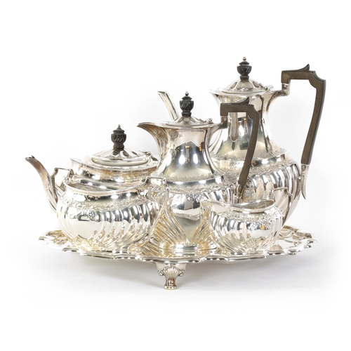 331 - AN EDWARD VII FIVE PIECE SILVER TEA SERVICE TOGETHER WITH A SILVER PLATED SALVER of oblate swirl-flu... 