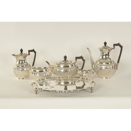 331 - AN EDWARD VII FIVE PIECE SILVER TEA SERVICE TOGETHER WITH A SILVER PLATED SALVER of oblate swirl-flu... 