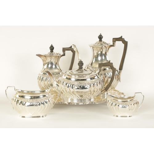 331 - AN EDWARD VII FIVE PIECE SILVER TEA SERVICE TOGETHER WITH A SILVER PLATED SALVER of oblate swirl-flu... 