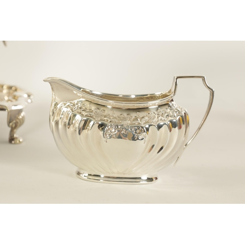 331 - AN EDWARD VII FIVE PIECE SILVER TEA SERVICE TOGETHER WITH A SILVER PLATED SALVER of oblate swirl-flu... 