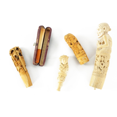 342 - FOUR 19TH CENTURY CARVED IVORY STICK HANDLES together with an ivory and amber cheroot holder.