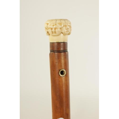 346 - A 19TH CENTURY CARVED IVORY AND MALACA ‘SEVEN FACES’ WALKING STICK with carved handle and tapering s... 