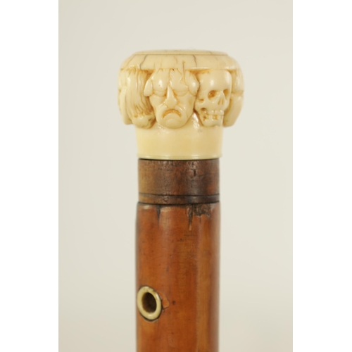 346 - A 19TH CENTURY CARVED IVORY AND MALACA ‘SEVEN FACES’ WALKING STICK with carved handle and tapering s... 