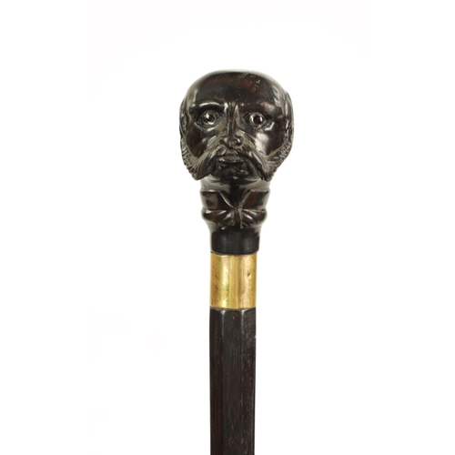 352 - A LATE 19TH CENTURY CARVED EBONY WALKING STICK depicting a bearded man with glass eyes (86.5cm overa... 