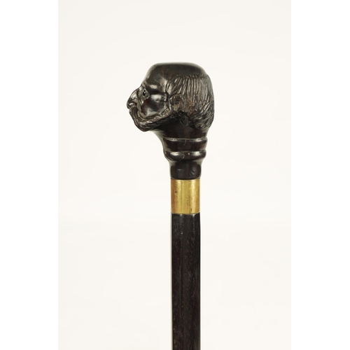 352 - A LATE 19TH CENTURY CARVED EBONY WALKING STICK depicting a bearded man with glass eyes (86.5cm overa... 