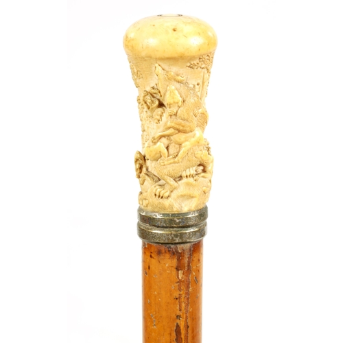 356 - A 19TH CENTURY CARVED IVORY AND MALACCA WALKING STICK the handle finely carved depicting a bear bein... 