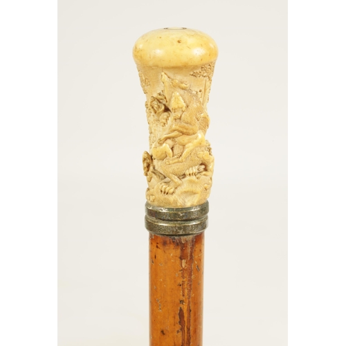 356 - A 19TH CENTURY CARVED IVORY AND MALACCA WALKING STICK the handle finely carved depicting a bear bein... 