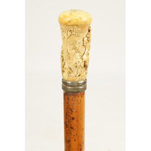 356 - A 19TH CENTURY CARVED IVORY AND MALACCA WALKING STICK the handle finely carved depicting a bear bein... 