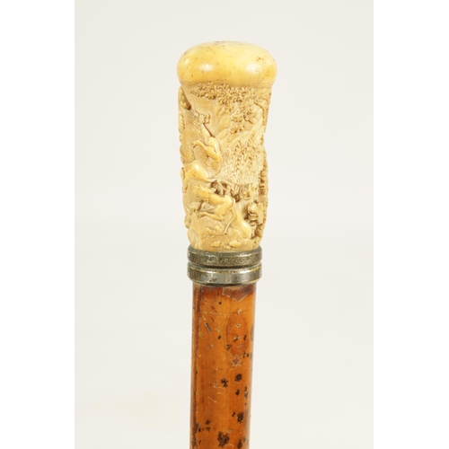 356 - A 19TH CENTURY CARVED IVORY AND MALACCA WALKING STICK the handle finely carved depicting a bear bein... 