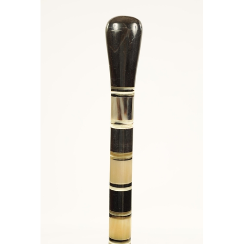 359 - A 19TH CENTURY SECTIONAL HORN WALKING STICK constructed of contrasting bands of horn (possibly rhino... 