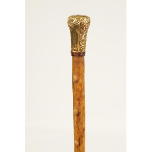 372 - A 19TH CENTURY RHINOCEROS HORN WALKING STICK with gilt metal embossed handle and branch effect taper... 