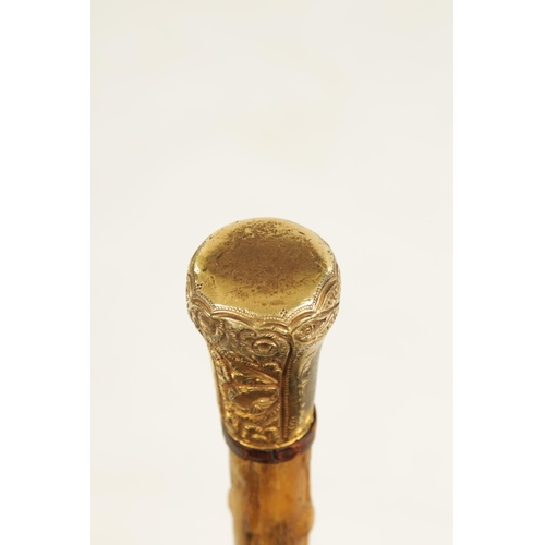 372 - A 19TH CENTURY RHINOCEROS HORN WALKING STICK with gilt metal embossed handle and branch effect taper... 