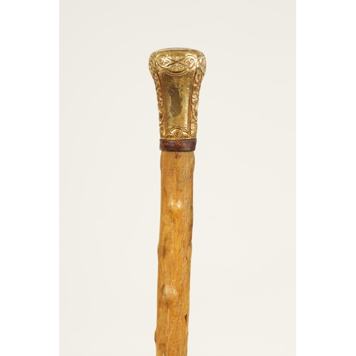 372 - A 19TH CENTURY RHINOCEROS HORN WALKING STICK with gilt metal embossed handle and branch effect taper... 