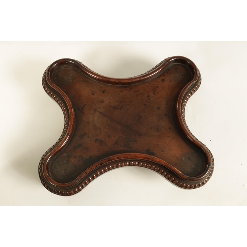 453 - A LATE GEORGIAN MAHOGANY TABLE URN STAND IN THE MANNER OF GILLOWS of all-round serpentine outline wi... 