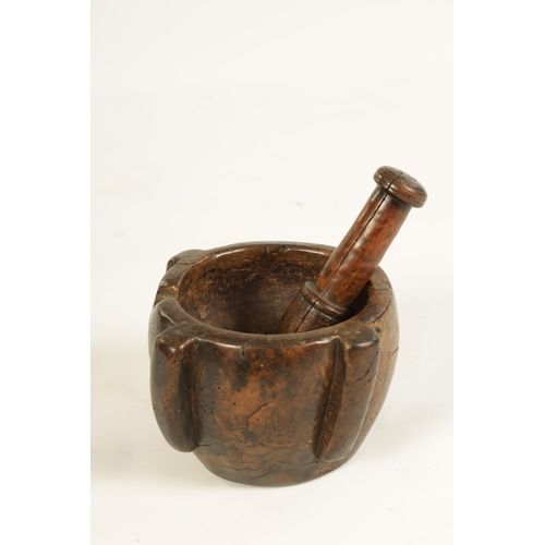 454 - AN EARLY 16TH/17TH CENTURY BURR WALNUT PESTLE AND MORTAR of deep four lugged form with rounded body ... 