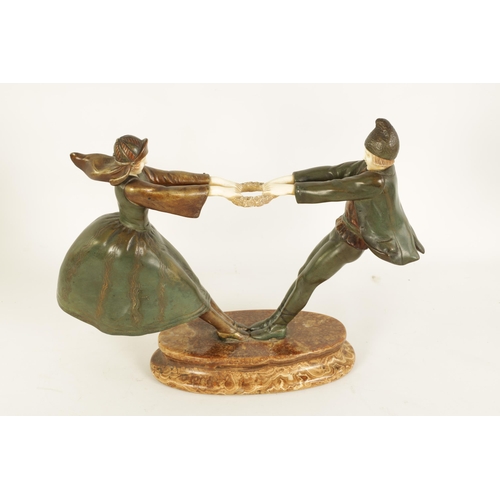 493 - AN ART DECO FIGURAL BRONZE AND IVORY SCULPTURE depicting a boy and a girl dancing with a ring of ros... 