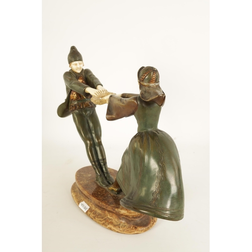 493 - AN ART DECO FIGURAL BRONZE AND IVORY SCULPTURE depicting a boy and a girl dancing with a ring of ros... 