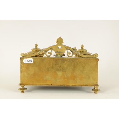 497 - A 19TH CENTURY BRASS AND ROUGE MARBLE DESK STAND the raised back with centre cresting and fitted dou... 