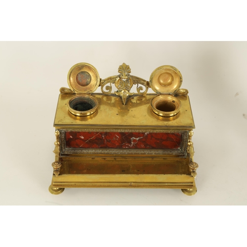 497 - A 19TH CENTURY BRASS AND ROUGE MARBLE DESK STAND the raised back with centre cresting and fitted dou... 