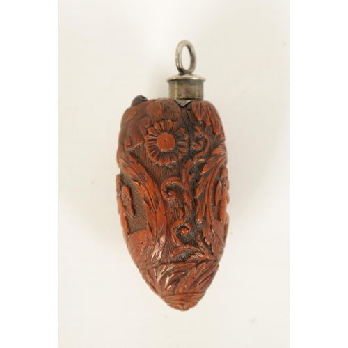 508 - A FINELY CARVED 19TH CENTURY FRENCH COQUILLA NUT SCENT FLASK the tear-drop body decorated with winge... 