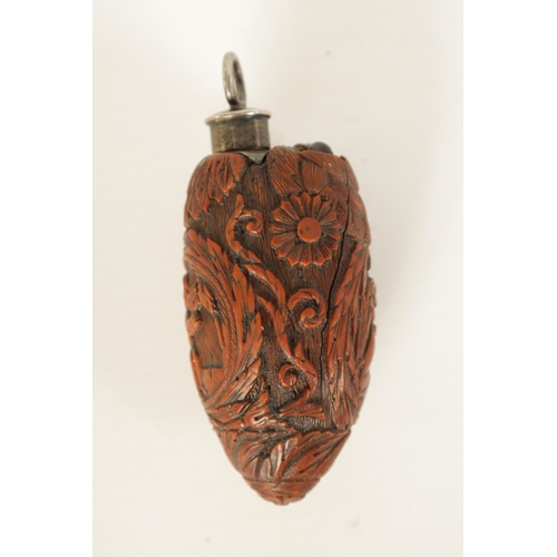 508 - A FINELY CARVED 19TH CENTURY FRENCH COQUILLA NUT SCENT FLASK the tear-drop body decorated with winge... 