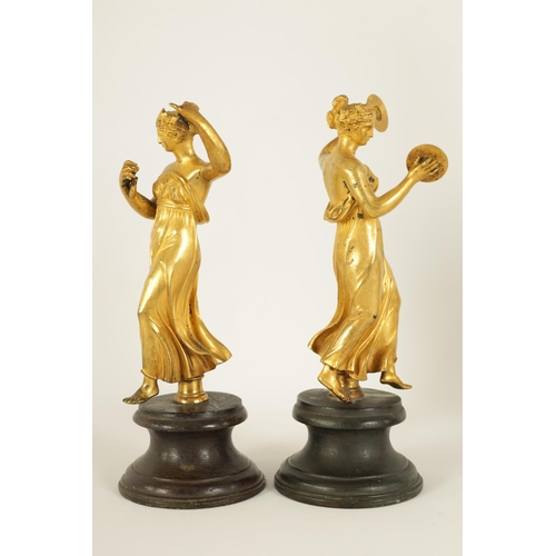 513 - A PAIR OF 19TH CENTURY FIGURAL GILT BRONZE SCULPTURES modelled as classical maidens playing symbols ... 