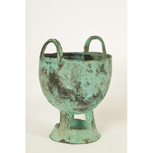 515 - AN ANCIENT PATINATED BRONZE TWO HANDLED VESSEL - POSSIBLY ROMAN with ring handles and openwork flare... 