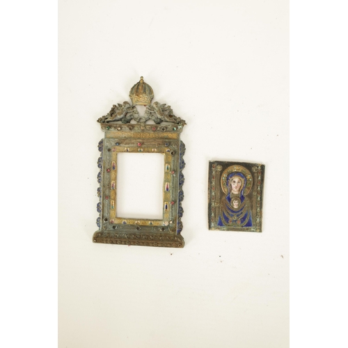 517 - AN EARLY SILVER AND ENAMEL RELIGIOUS PLAQUE DEPICITING THE VIRGIN MOTHER AND CHILD finely worked wit... 