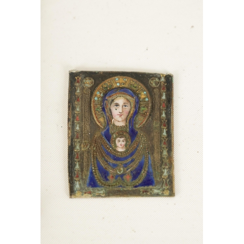 517 - AN EARLY SILVER AND ENAMEL RELIGIOUS PLAQUE DEPICITING THE VIRGIN MOTHER AND CHILD finely worked wit... 