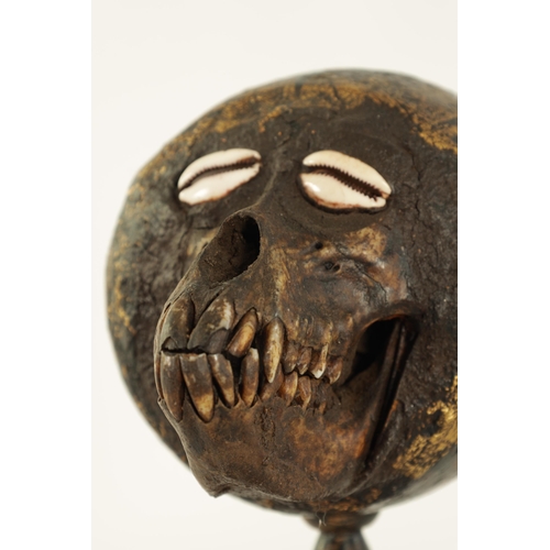 518 - AN UNUSUAL TRIBAL SOUTH ISLANDS SCULPTURE depicting a monkey skull set in a coconut with sea shell e... 