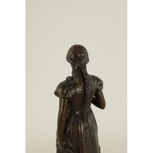 519 - ARNOLDT KUNNE (1866 1942) AN EARLY 20TH CENTURY GERMAN BRONZE SCULTURE modelled as a girl holding a ... 