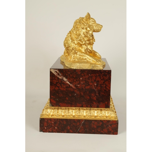 524 - A 19TH CENTURY GILT METAL AND ROUGE VEINED MARBLE SCULPTURE depicting a reclining dog, mounted on a ... 