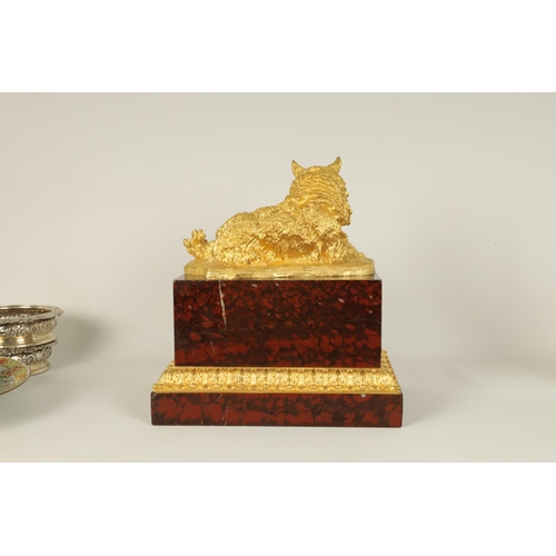 524 - A 19TH CENTURY GILT METAL AND ROUGE VEINED MARBLE SCULPTURE depicting a reclining dog, mounted on a ... 