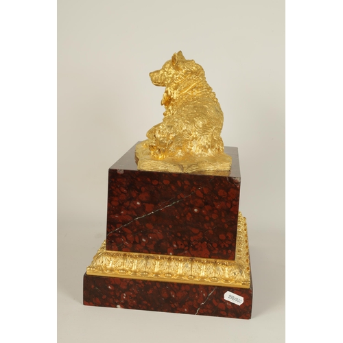 524 - A 19TH CENTURY GILT METAL AND ROUGE VEINED MARBLE SCULPTURE depicting a reclining dog, mounted on a ... 